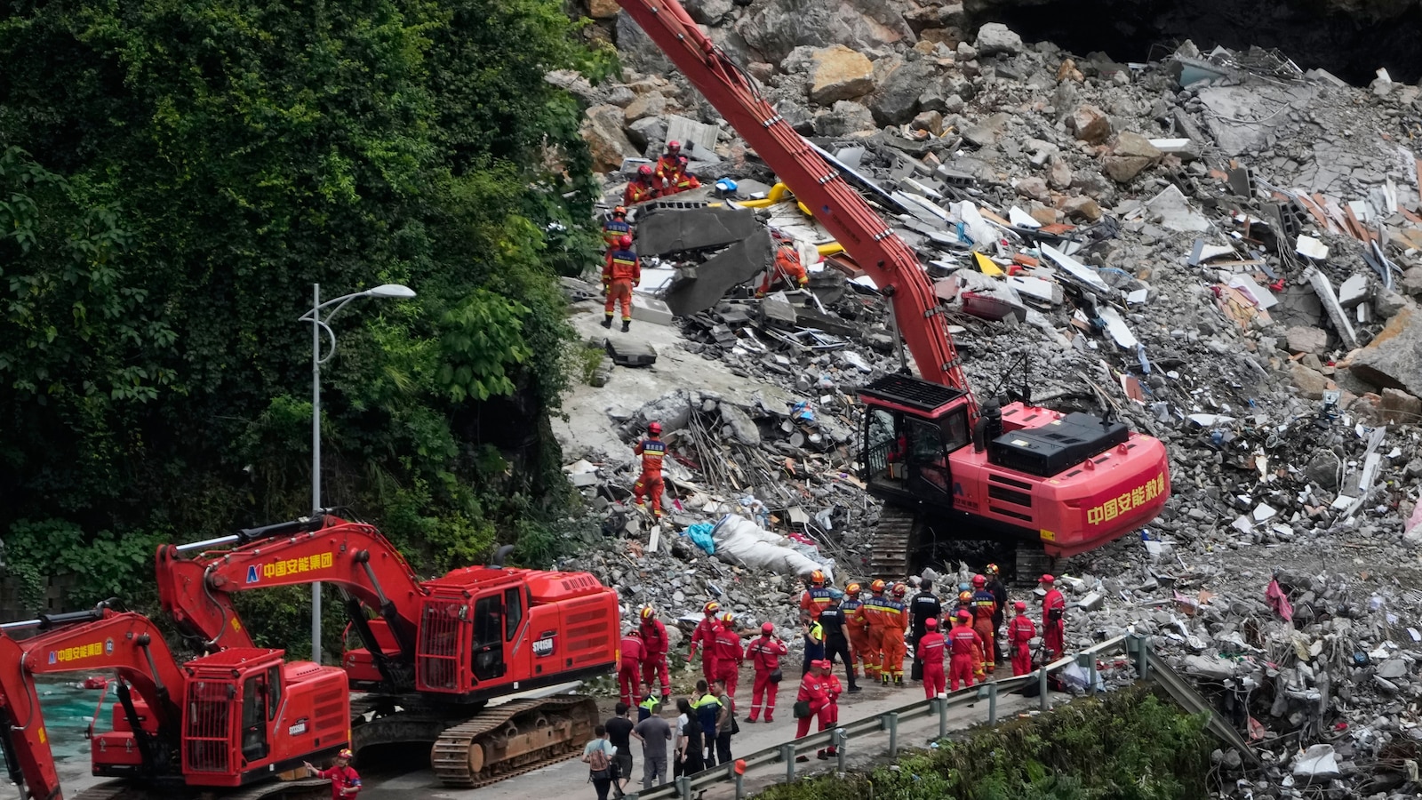 Rescuers race to find survivors in the rain after a landslide in China kills at least 8