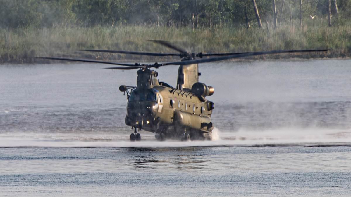 Hair-raising moment RAF Chinook pilot shows incredible skill by hovering just inches above the water to drop off Royal Marines in dramatic training exercise