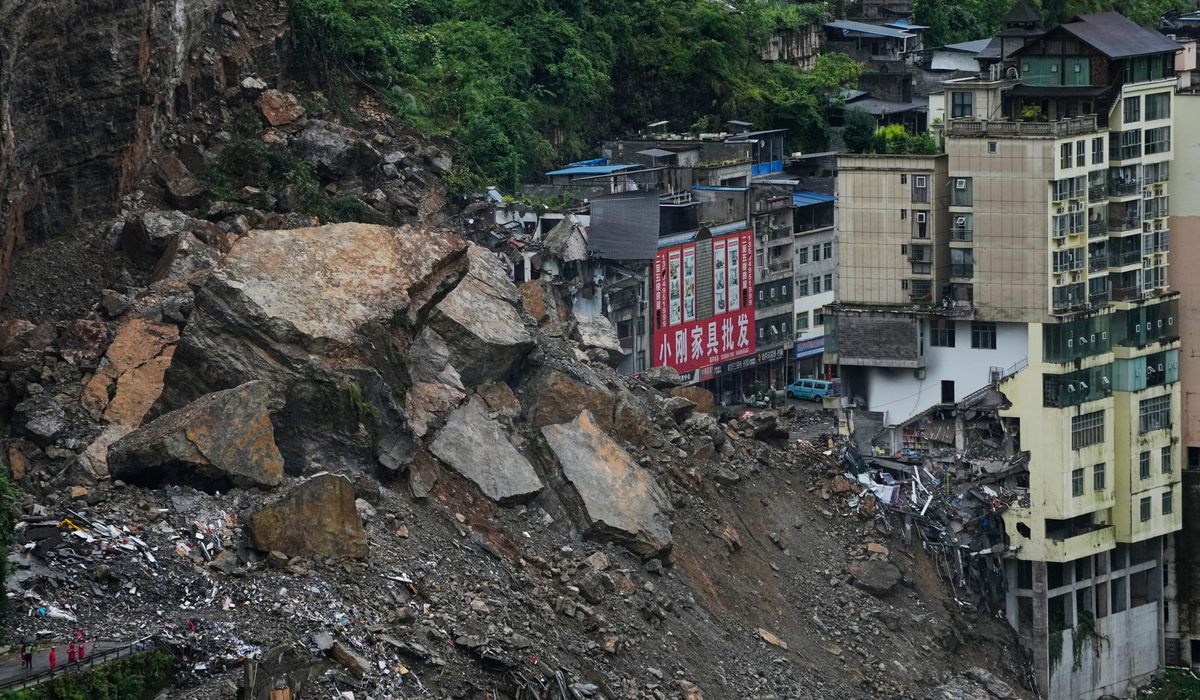 Rescuers race to find survivors in the rain after a landslide in China kills at least 8