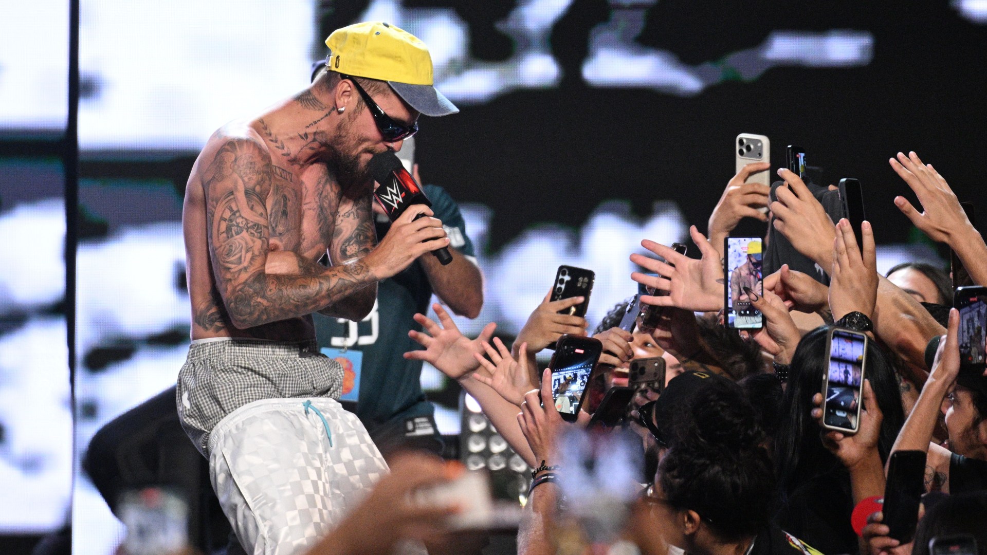 Shirtless Justin Bieber surprises fans at Fanatics Fest a day before he takes centre stage at the World Cup final