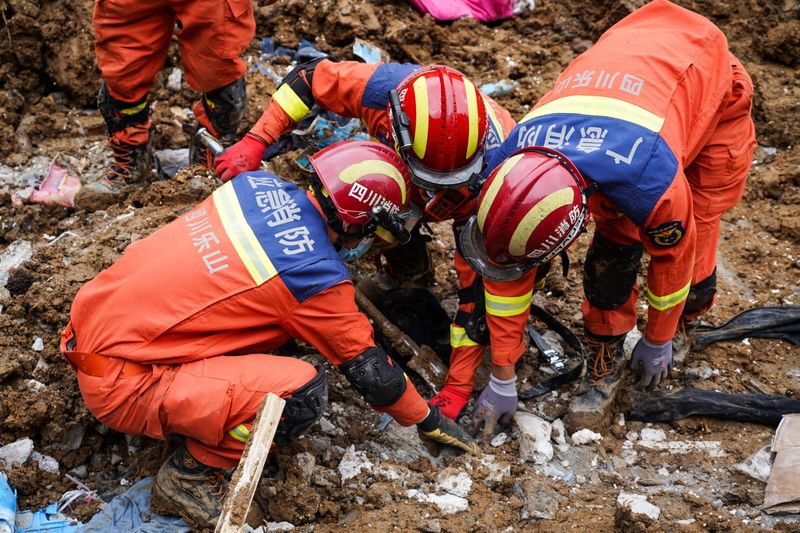 Chinese rescuers use explosives to clear boulders trapping landslide victims